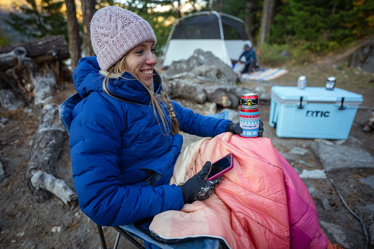 Women's down jacket (sitting by campfire in Rab Cubit Stretch Down Hoody)